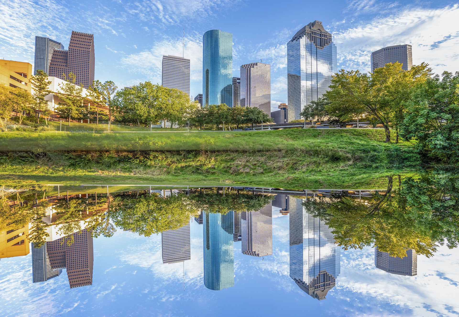 skyline of Houston, Texas in morning light seen from Buffalo bayou park and reflection in river